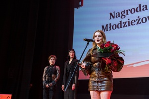 38. TNF - Dzień 9 (8.06.2024) - Na scenie aktorka Bogumiła Bajor z filmu "Kobieta z..." w imieniu reżyserów Małgorzaty Szumowskiej i Michała Englerta dziękuje za nagrodę. W tle przedstawiciele Jury Młodzieżowego 38. TNF